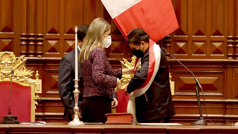 Pedro Castillo receives the presidential sash from the president of the Congress, Maria del Carmen Alva