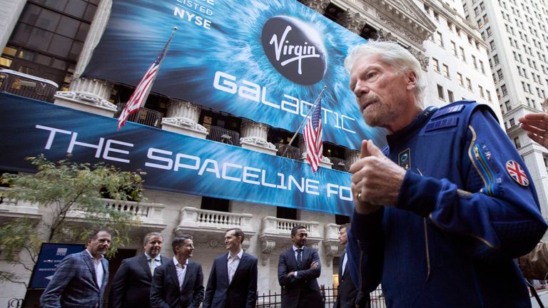 FILE - In this Monday, Oct. 28, 2019 file photo, Richard Branson, right, founder of Virgin Galactic, and company executives gather for photos outside the New York Stock Exchange before his company&#39;s IPO. Branson announced Thursday, July 1, 2021 he plans to fly into space this month on the next test flight of his Virgin Galactic rocket ship. The launch window will open July 11. (AP Photo/Richard Drew, File)