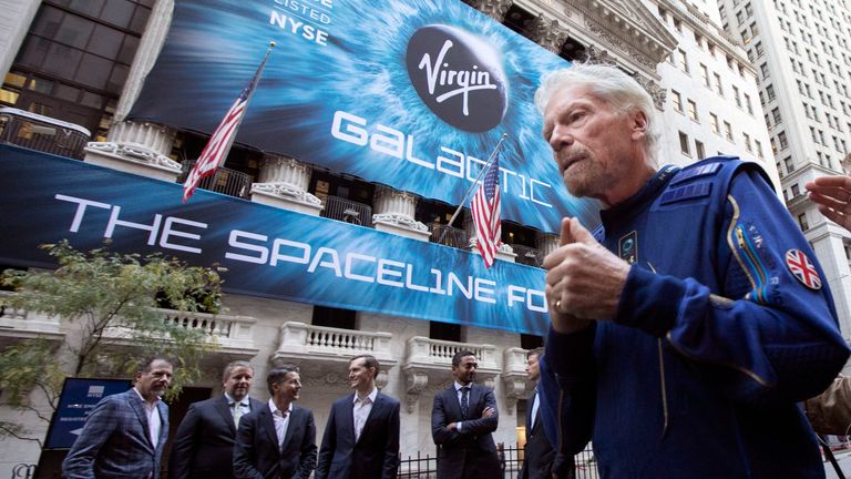 Files - on this Monday in October.  In this Jan. 28, 2019, file photo, Virgin Galactic founder Richard Branson, right, and company executives pose for a picture outside the New York Stock Exchange ahead of the company's initial public offering. Branson announced on Thursday, July 1, 2021, that he plans to fly into space this month on the next test flight of his Virgin Galactic rocket ship. The launch window will open on July 11th.  (AP Photo/Richard Drew, File)