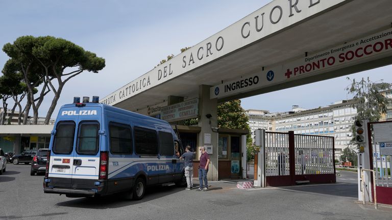 A police van is parked at the entrance of Rome&#39;s Gemelli Polyclinic where Pope Francis has been hospitalized for a scheduled surgery for a stenosis, or restriction, of the large intestine, the Vatican said Sunday, July 4, 2021. The news came just three hours after Francis had cheerfully greeted the public in St. Peter’s Square and told them he will go to Hungary and Slovakia in September. (AP Photo/Alessandra Tarantino)