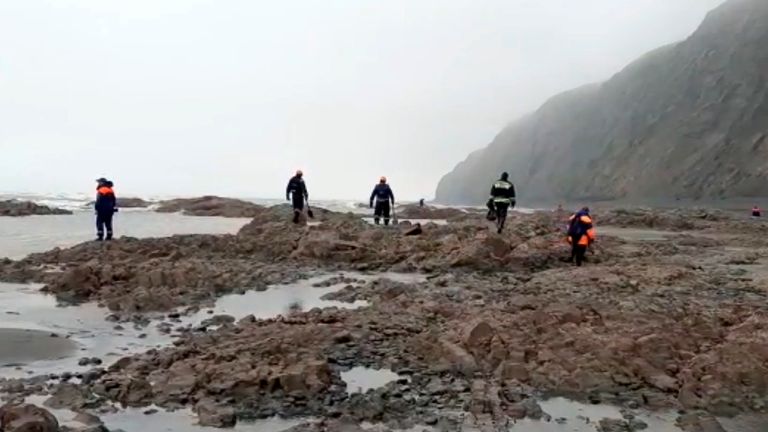 This photo taken from video released by the Russia Emergency Situations Ministry press service on Wednesday, July 7, 2021, shows Emergency Situations Ministry workers at the wreckage of a missing Antonov An-26 missing plane found near its destination airport outside the town of Palana, in Russia&#39;s Far East. Authorities in Russia say rescuers have found the bodies of nine victims a day after a plane crash in a remote area in the country&#39;s Far East. (Russia Emergency Situations Ministry press serv