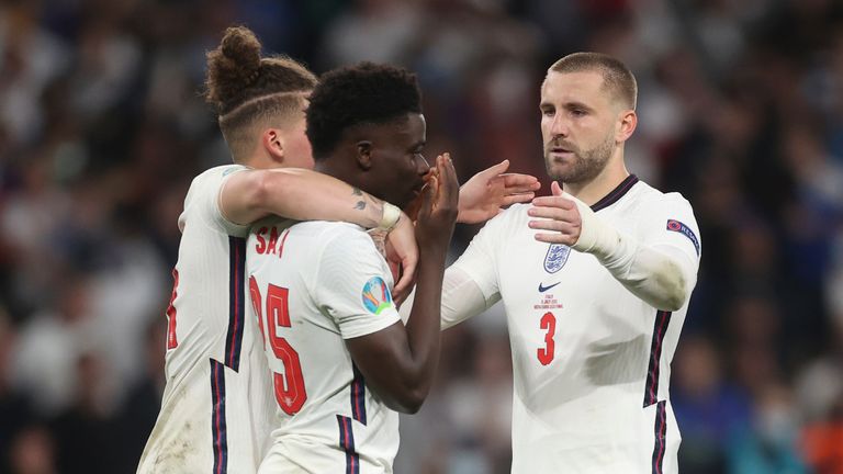 England&#39;s Kalvin Phillips, left, and Luke Shaw, right, comfort teammate Bukayo Saka. Pic: AP