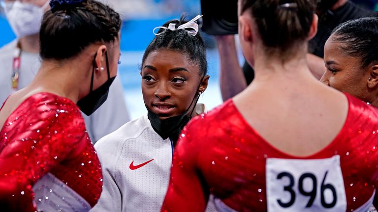 Simone Biles talks to her US team-mates during the final