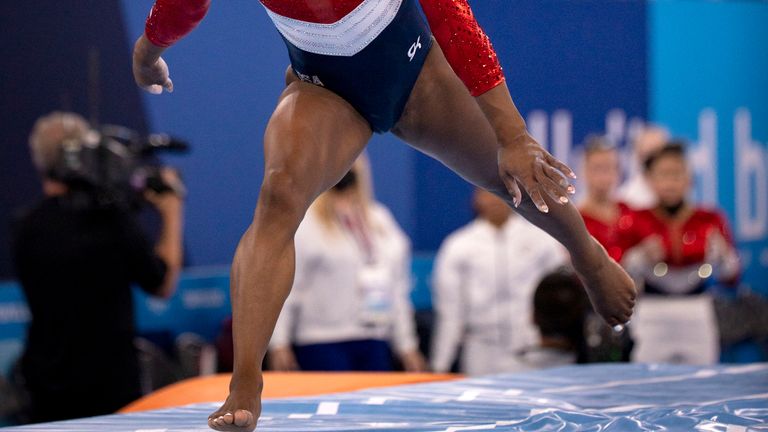 Simone Biles takes a huge step forward as she lands after the completing the vault, shortly before she withdrew. Pic: AP