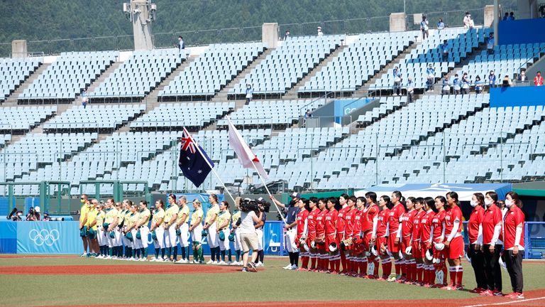 Jul 21, 2021; Fukushima, Japan; Japan and Australia line up for their national anthems before a softball opening round game during the Tokyo 2020 Olympic Summer Games at Fukushima Azuma Stadium. Mandatory Credit: Yukihito Taguchi-USA TODAY Network