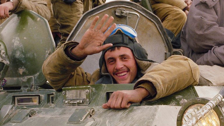 ** FILE ** A smile and a wave from a happy Soviet soldier, as his armoured convoy makes its way back to the Soviet Union along a north Afghanistan highway in this Sunday, Feb. 7, 1989, file photo. The Soviet Union lost some 15,000 soldiers in the war, which began in 1979 when Moscow sent in troops to battle guerrillas who were fighting a Soviet-supported government.  (AP Photo/Boris Yurchenko, File)