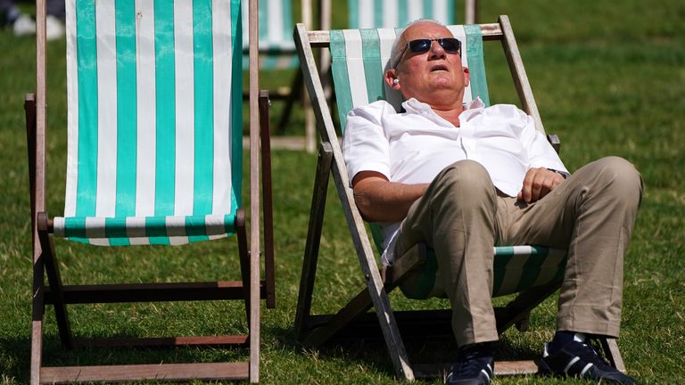 A Sunbather lounges on a deck chair in Green Park, London. Picture date: Saturday July 17, 2021.

