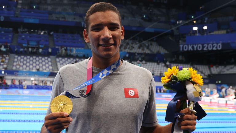 Ahmed Hafnaoui of Tunisia poses with the gold medal