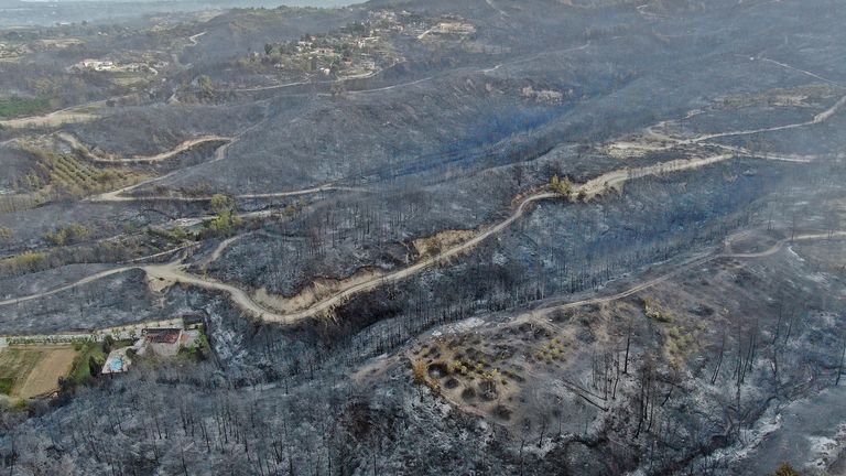 (IHA via Suite Metin / AB) 29 Temmuz 2021 Perşembe günü Türkiye'nin Antalya ilinde bir Akdeniz sahil kasabası olan Manavkot yakınlarındaki orman yangınları devam ederken bir köyde yıkılan evleri havadan çekilmiş bir fotoğrafta gösteriyor.  Akdeniz sahil kasabası Manavkat yakınlarındaki bir ormanda orman yangını yayıldı.  Kaymakam Mustafa Yikit'in oturduğunu söyledi