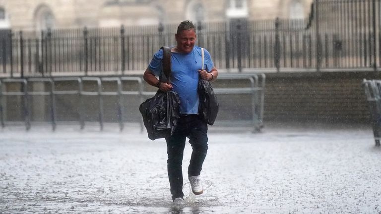 Heavy rain is falling on central London as the Met Office has issued amber warnings for the South
