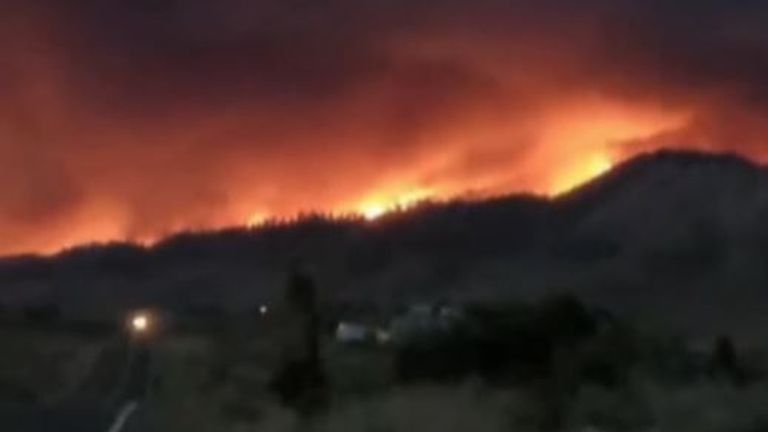 California wildfire burns into the night