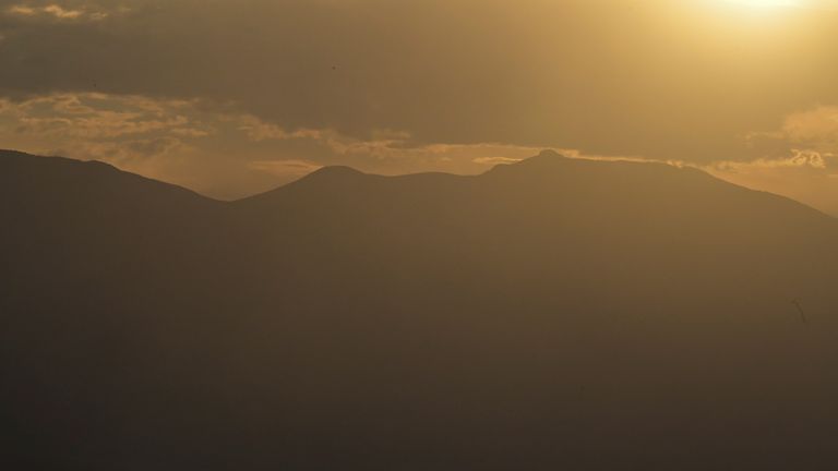 A dust storm is seen approaching as the sun sets in Death Valley, California