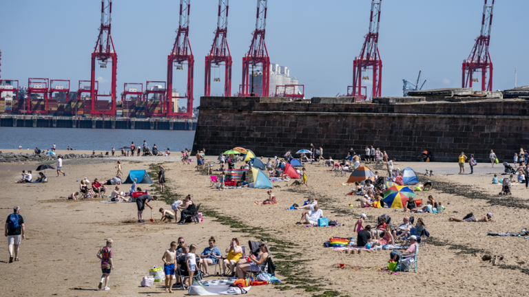 Sunbathers make the most of the mini heatwave in New Brighton, Wirral, on what could be the hottest day of the year. Picture date: Saturday July 17, 2021.