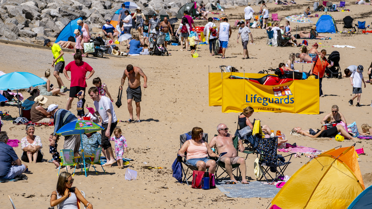 Sunbathers make the most of the mini heatwave in New Brighton, Wirral, on what could be the hottest day of the year. Picture date: Saturday July 17, 2021.