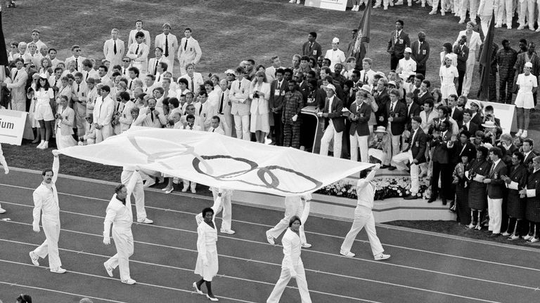 Tyus (third from left) helps to carry the Olympic flag in Los Angeles during the 1984 opening ceremony.