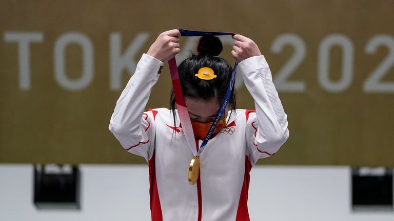 Yang Qian, of China, puts her gold medal on herself