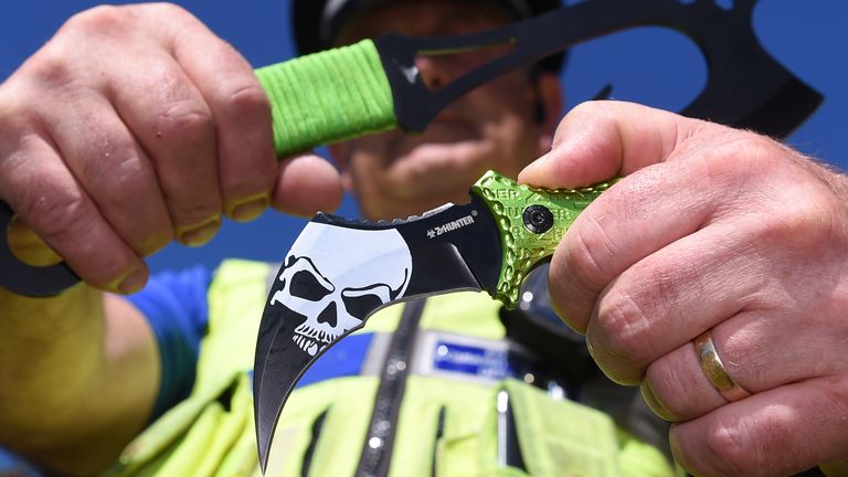 West Midlands PCSO Rob Capella holds two examples of &#39;zombie knives&#39; at a secure police location in Birmingham in 2016