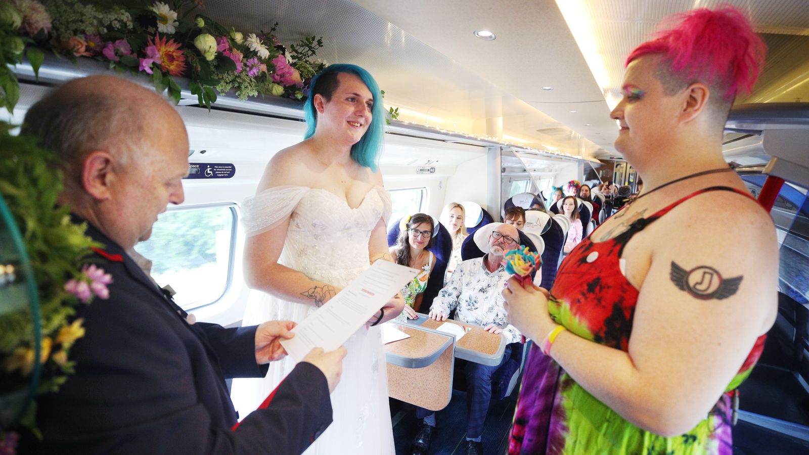 A very moving service: Rail enthusiasts get married on train from London Euston
