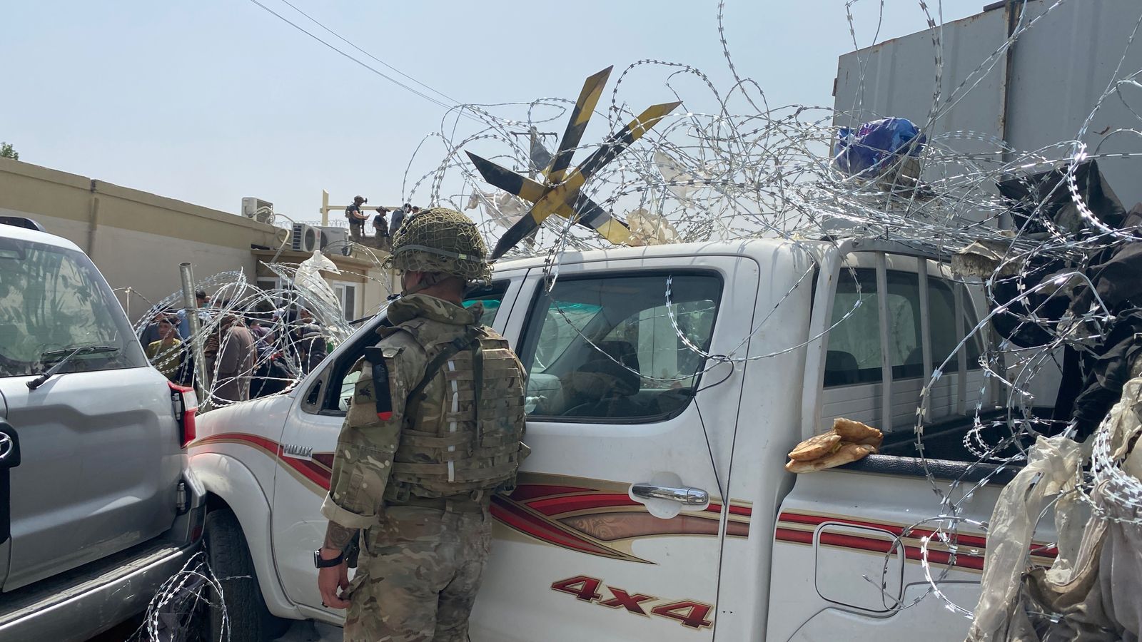 Afghanistan: Desperate women throw babies over razor wire at compound, asking British soldiers to take them