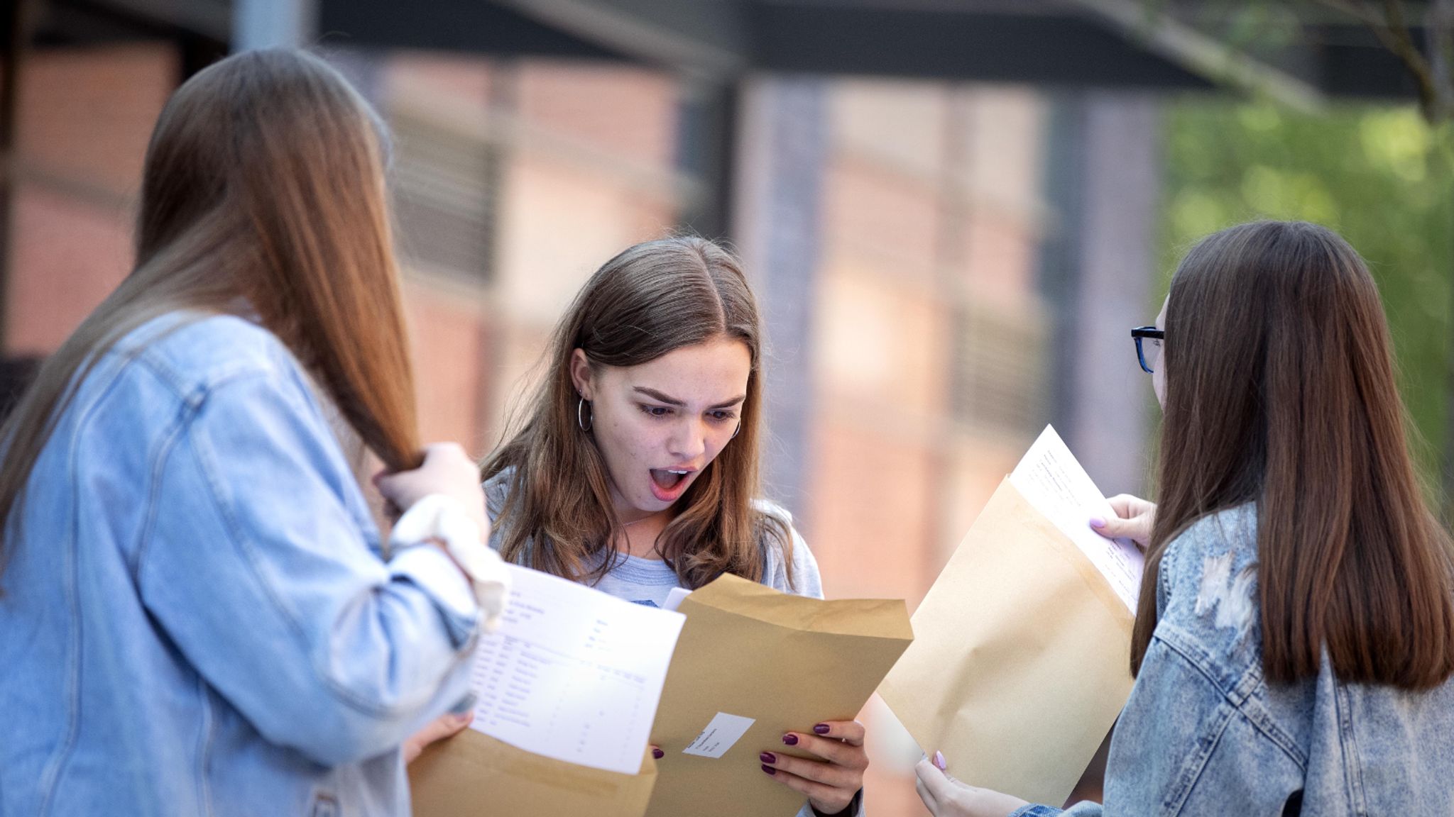 What is the reason for the increase in the number of students getting A  grades in their GCSEs in the UK? Is it because the exams are easier now, or  because more