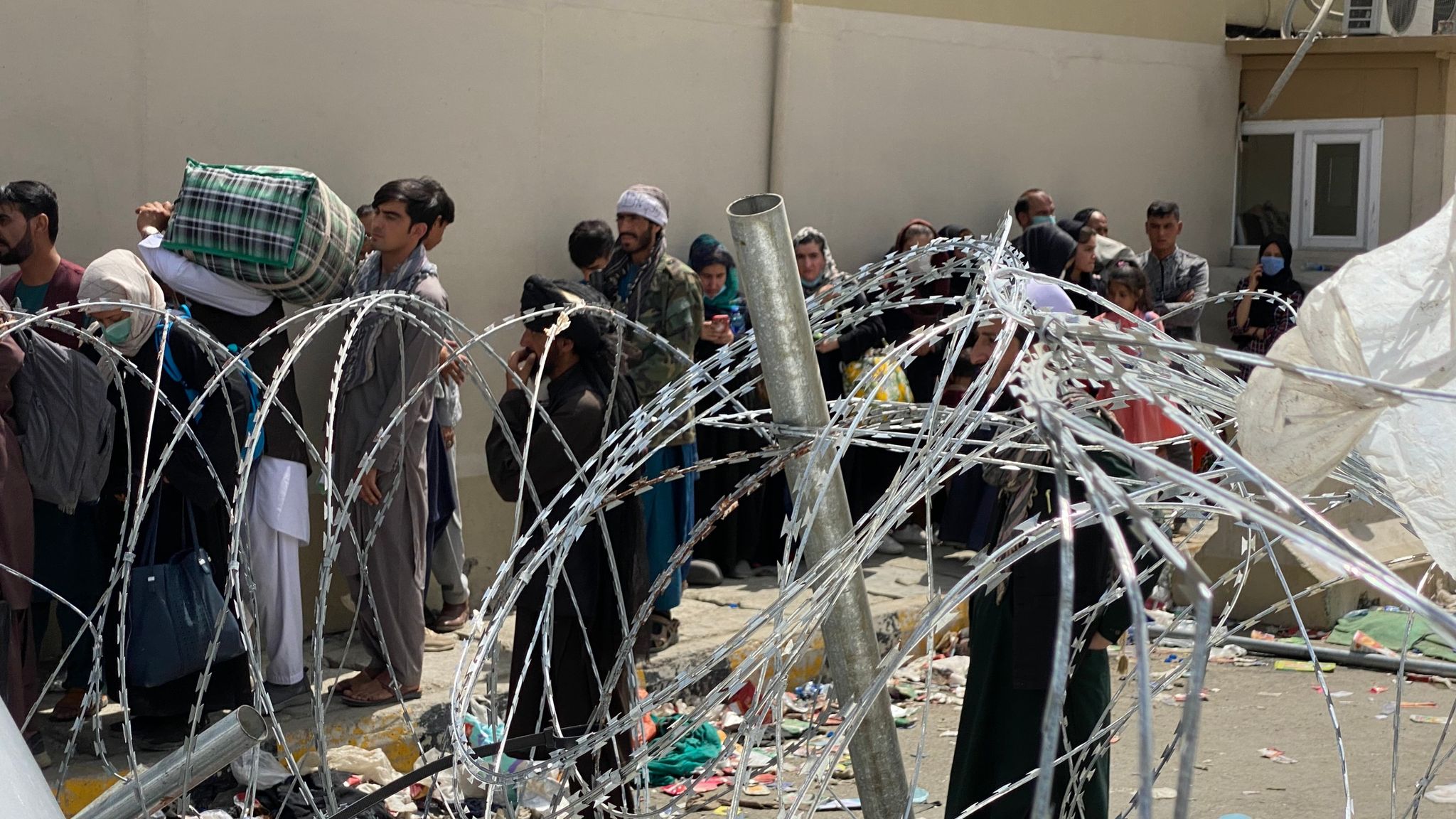 Afghanistan Desperate women throw babies over razor wire at compound