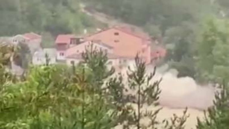 Video from an eyewitness shows the moment a house collapses into fast flowing floodwaters in Turkey. 