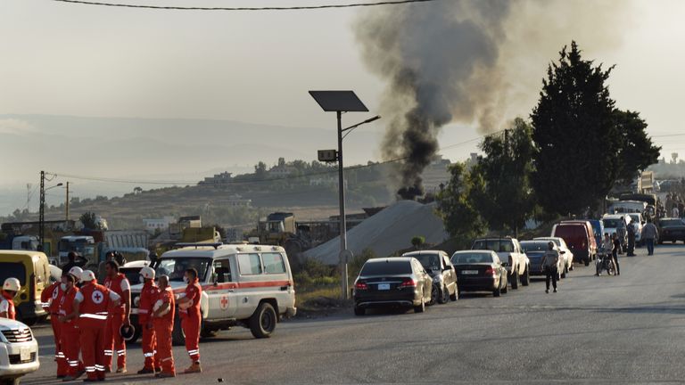 Lebanese Red Cross volunteers gather at a street next to the scene where a fuel tanker exploded, in Tleil village, north Lebanon, Sunday, Aug. 15, 2021. A fuel tanker exploded early Sunday in northern Lebanon, killing and wounded several people, the Lebanese Red Cross said. The explosion comes as Lebanon faces a severe fuel shortage that has been blamed on smuggling, hoarding and the cash-strapped government&#39;s inability to secure deliveries of imported fuel. (AP Photo)