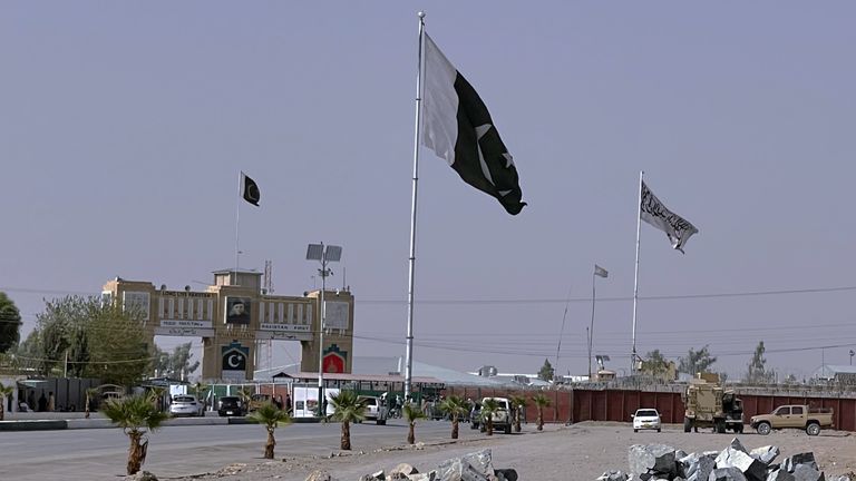 Pakistan and Taliban flags are seen on their respective sides near Friendship gate at a border crossing point in Chaman, Pakistan, Friday, Aug. 27, 2021. Hundreds of Pakistanis and Afghans cross the border daily through Chaman to visit relatives, receive medical treatment and for business-related activities. Pakistani has not placed any curbs on their movement despite recent evacuations from Kabul. (AP Photo)
