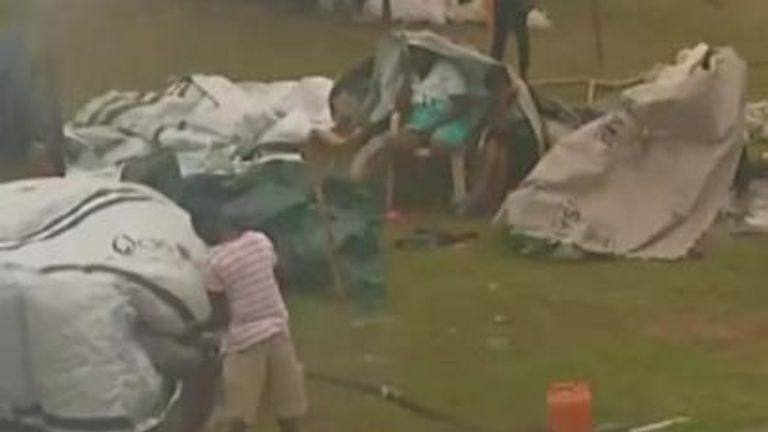 Haitians try to keep their shelters together as tropical storm Grace sweeps over Les Cayes. 