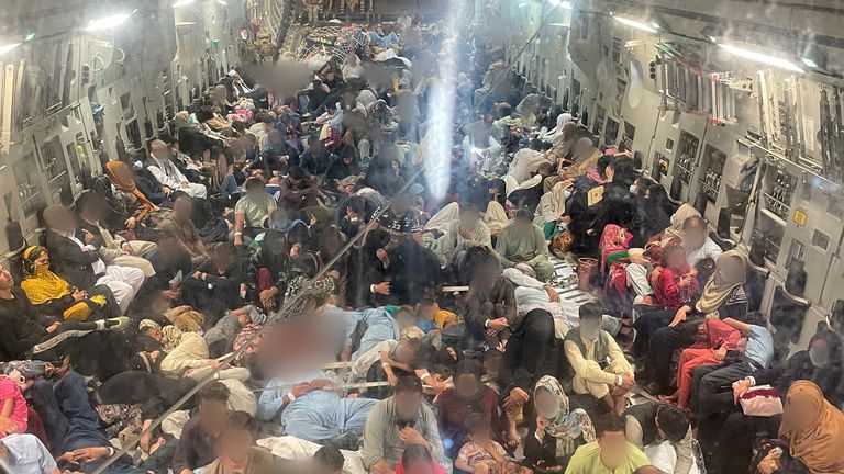 Passengers sit inside a Royal Air Force C-17 following evacuation from Kabul airport