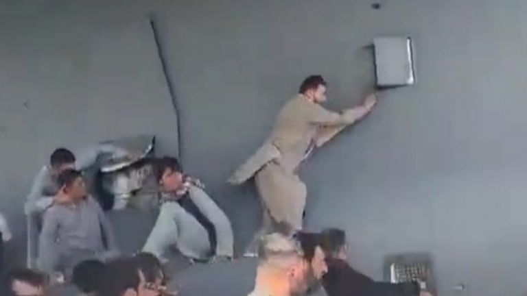 AFGHAN LOCALS CLING TO PLANE