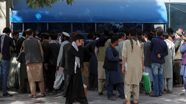 Afghans wait in long lines for hours in front of Kabul Bank to get their money. Pic: AP