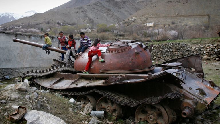 In this 2011 photo, Afghan children play on a destroyed Soviet - made armored tank in Panjshir north of Kabul, Afghanistan. Pic: AP
