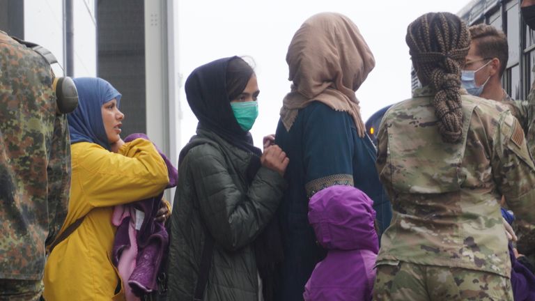 Refugees from Afghanistan board buses at Ramstein air base. The buses will take them to planes that will, in turn, take them to the US    