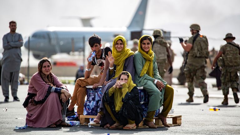 Children wait for the next flight out of Hamid Karzai International Airport in Kabul on Thursday after being told they are on the list to depart