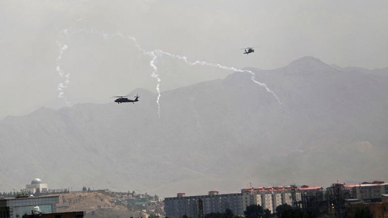 US Black Hawk military helicopters deploy anti-missile decoy flares over the city of Kabul. Pic: AP