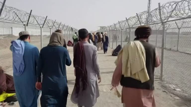 Afghans walk towards the border with Pakistan in a bid to escape the crisis