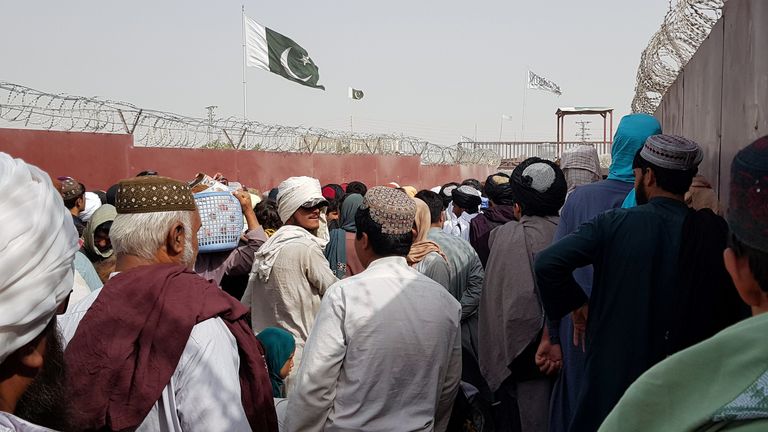 Afghans crowd the gate to the Pakistan border in a bid to flee the country