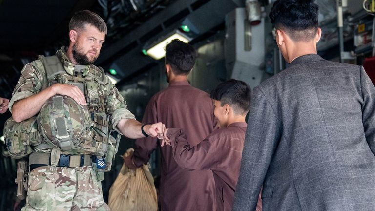 Afghan families get on a UK flight out of Kabul
