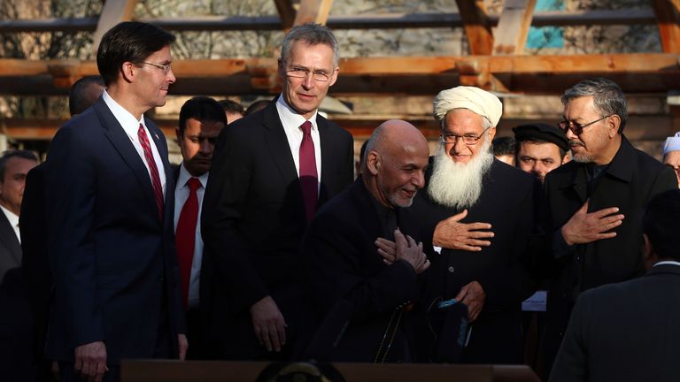 FILE- In this Feb. 29, 2020 file photo, Afghan President Ashraf Ghani, center, arrives with NATO Secretary General Jens Stoltenberg, second left, and then U.S. Secretary of Defense Mark Esper, left, for a joint news conference after the US signed a peace agreement with Taliban militants which includes a May 1, 2021, deadline for a final U.S. troop withdrawal, at the presidential palace in Kabul, Afghanistan. The Biden administration’s surprise announcement of an unconditional troop withdrawal fr