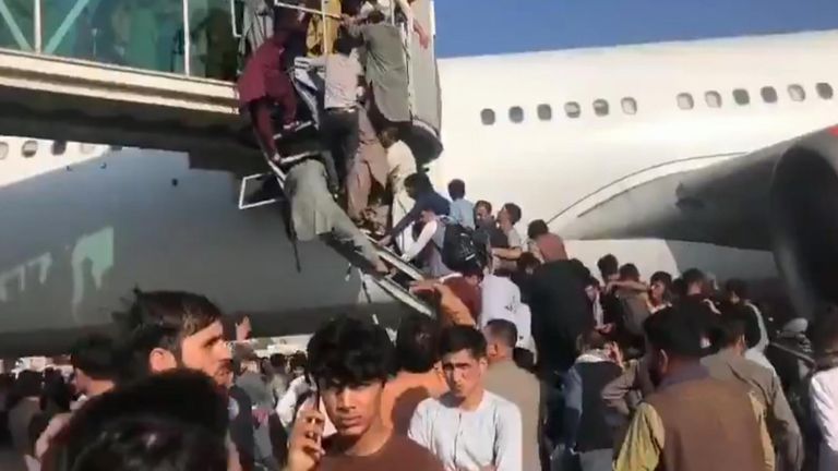 People have been trying to climb on to an airbridge at Kabul airport