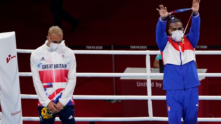 Gold Medalist Arlen Lopez, of Cuba (right) holds up his medal as sliver medalist Whittaker, looks on. Pic: AP