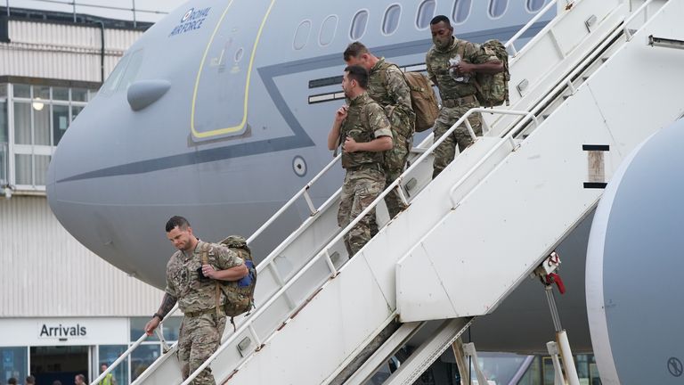 Members of 16 Air Assault Brigade get off their flight from Kabul