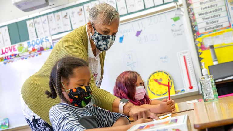 Students and staff will have to undergo weekly testing or be fully vaccinated from this month in California. Pic: AP