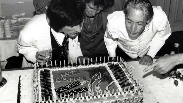 1990: Ronnie Wood, Keith Richards and Charlie Watts blowing out the candles on Ronnie and Charlie&#39;s birthday cake. Ronnie is 43 years old and Charlie is 49 years old. Pic: Eugene Adebari/Shutterstock