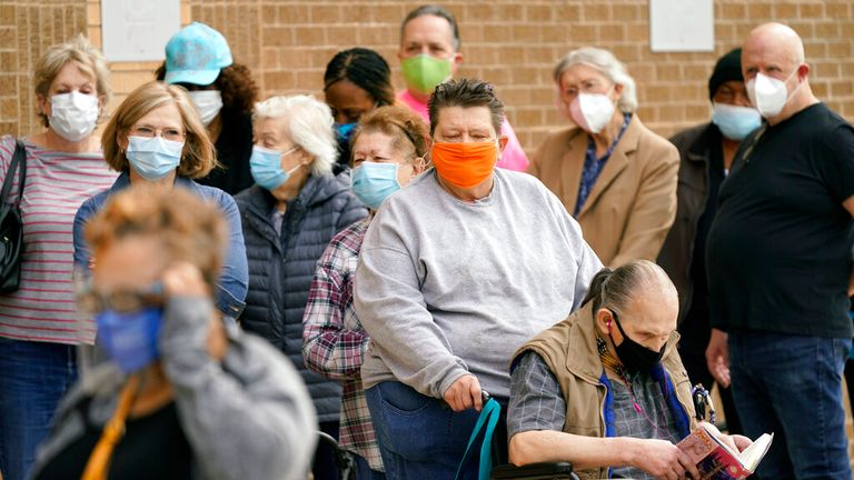 People are pictured queuing to get vaccines in Dallas amid high COVID rates. Pic: AP