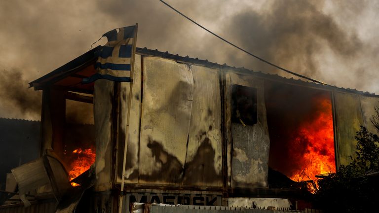 Homes and businesses have been destroyed in Greece, with thousands evacuated