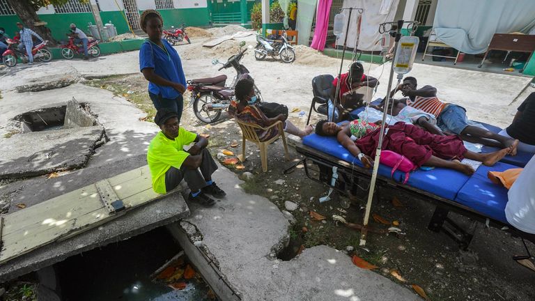 Injured people lie in beds outside the Immaculée Conception hospital in Les Cayes. Pic: AP