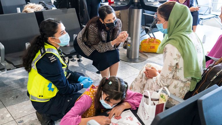 Home Secretary Priti Patel talking to a refugee from Afghanistan who arrived on a evacuation flight at Heathrow Pic: AP