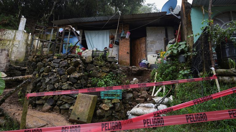 Red tape blocks the access to a house where several people were killed in a mudslide after Hurricane Grace pummeled Mexico with torrential rain on Saturday, in Xalapa, Mexico August 21, 2021. REUTERS/Yahir Ceballos